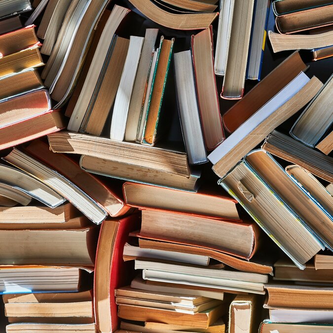 Libreria Aqua Alta | © Shutterstock 1555865240 Pile alter Bücher in dramatisch dunklem Licht | © Shutterstock 1555865240