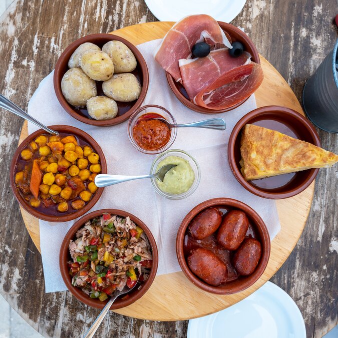 Tapas– der Tradition verpflichtet | © Shutterstock 2134161569 Mahlzeiten von sechs Tapas auf einer Terrasse | © Shutterstock 2134161569